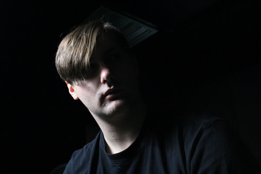 Studio portrait of a young man in low key light