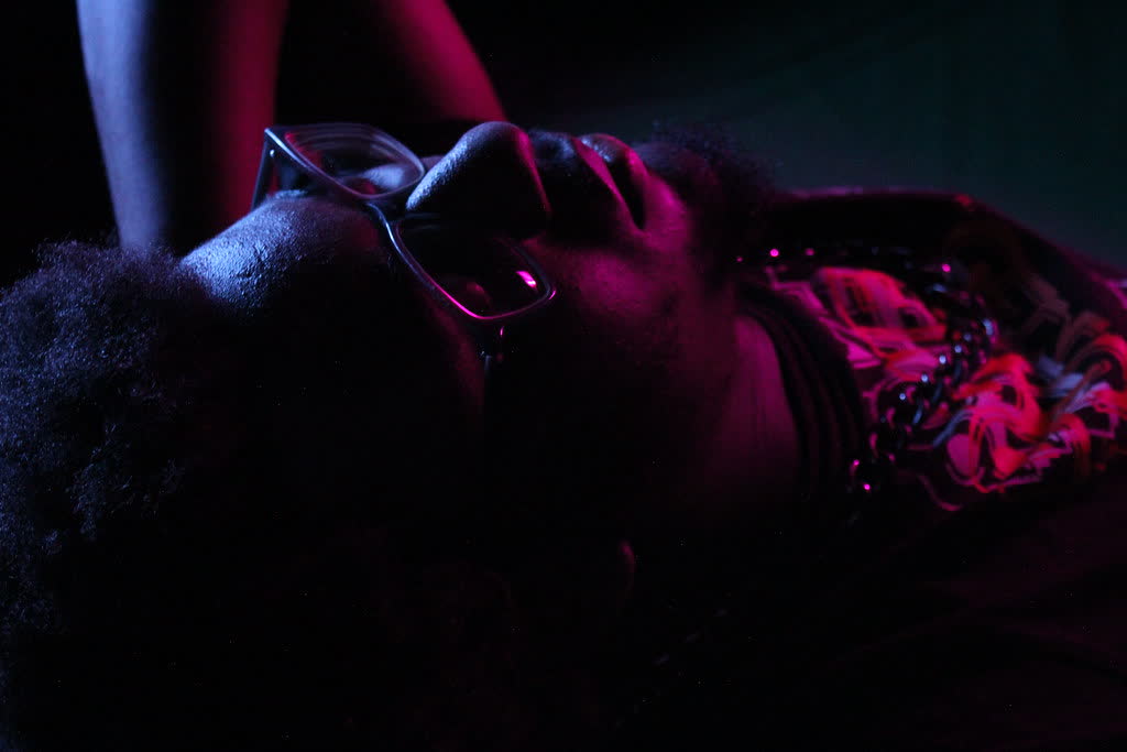 Portrait lit by pink and blue light