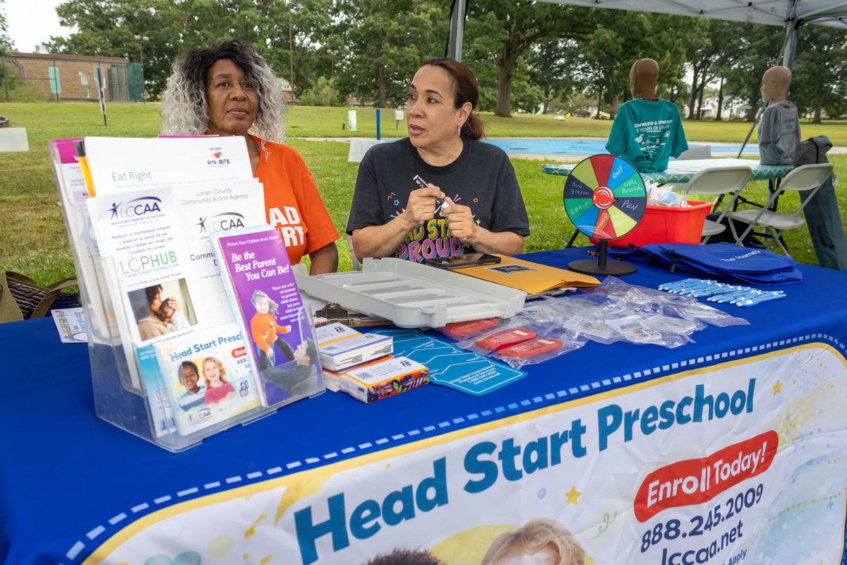 Volunteers at a Head Start table at a community fundraiser