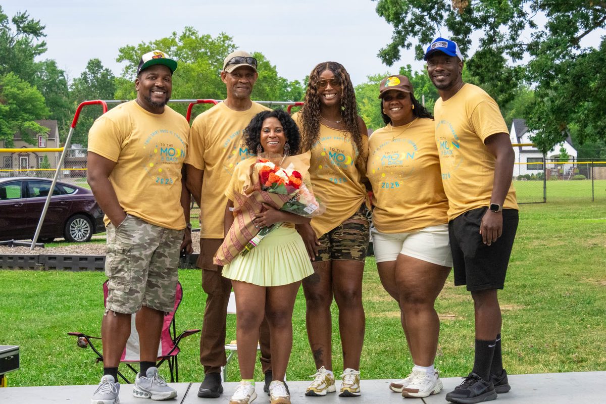 Family in matching yellow shirts with flowers