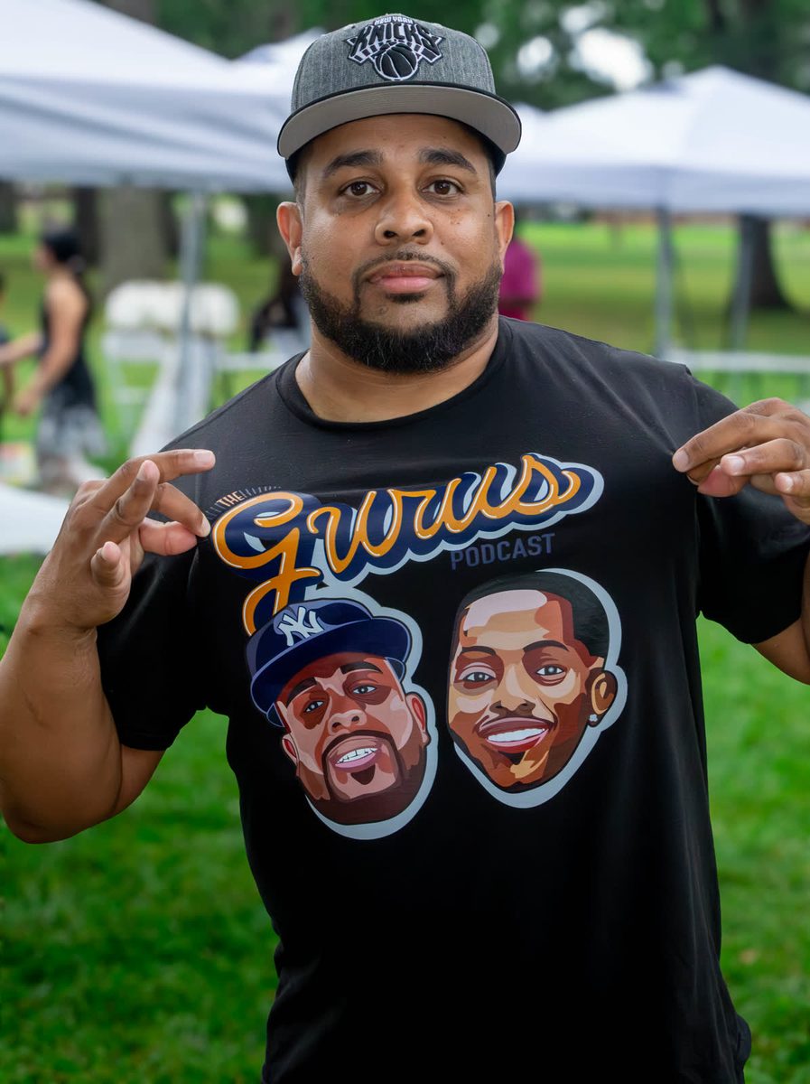 Man in a Gurus podcast shirt