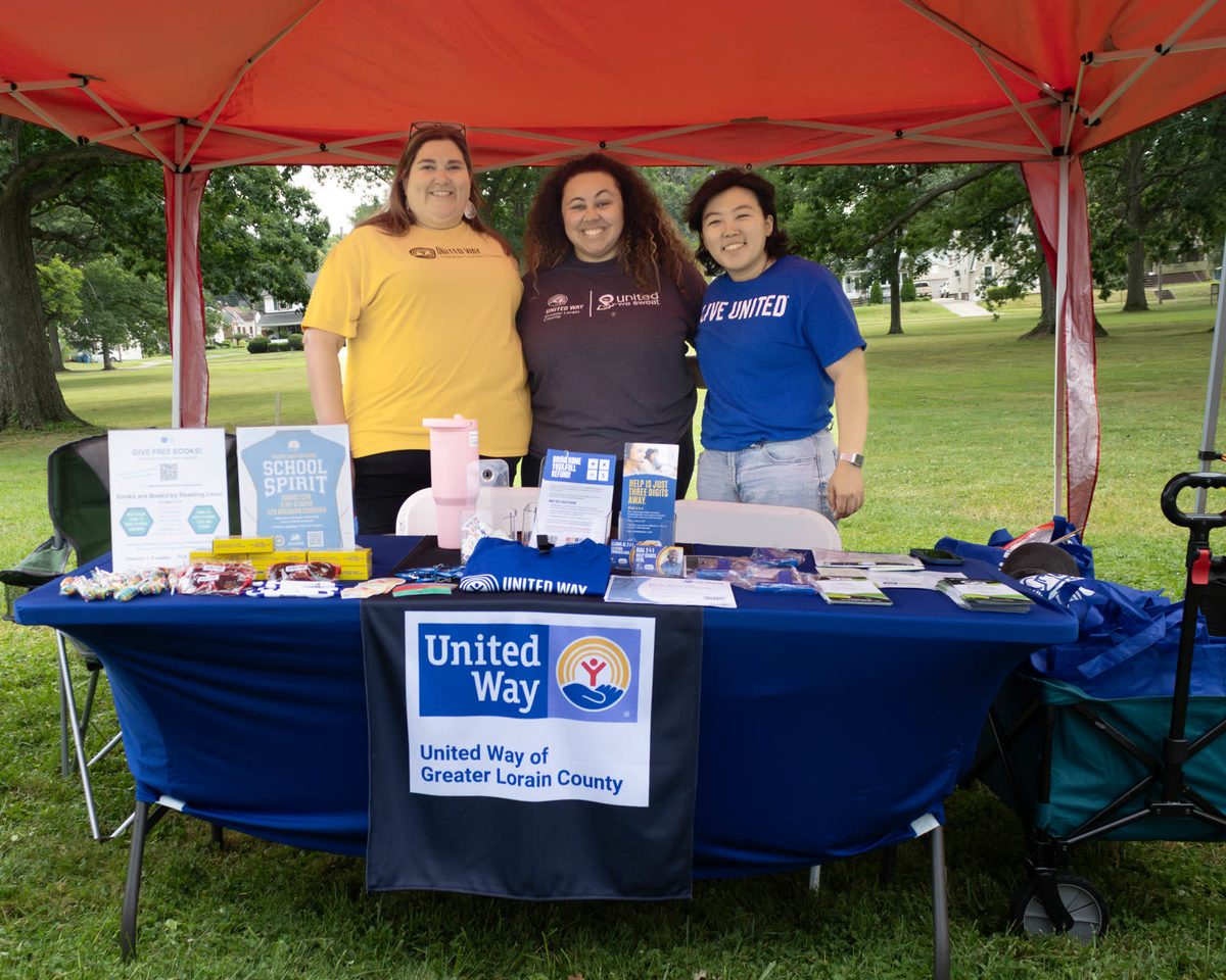 United Way volunteers under a red tent