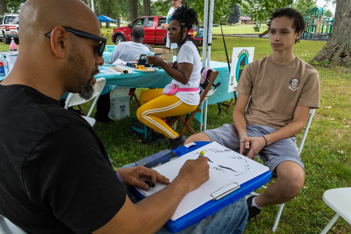 Artist sketching a portrait at a community event