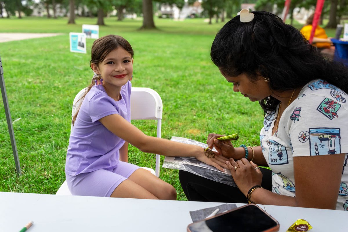 Girl getting a henna design at the fair