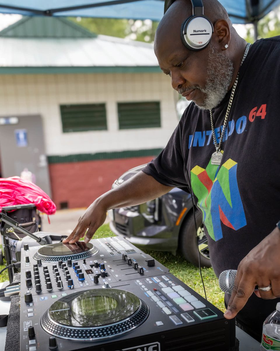 DJ on the turntables in a Nintendo shirt