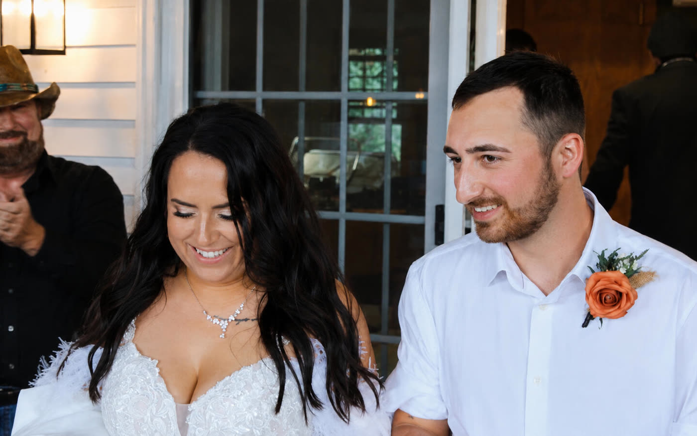 Bride and groom smiling as they walk into their reception, photographed by JS Media